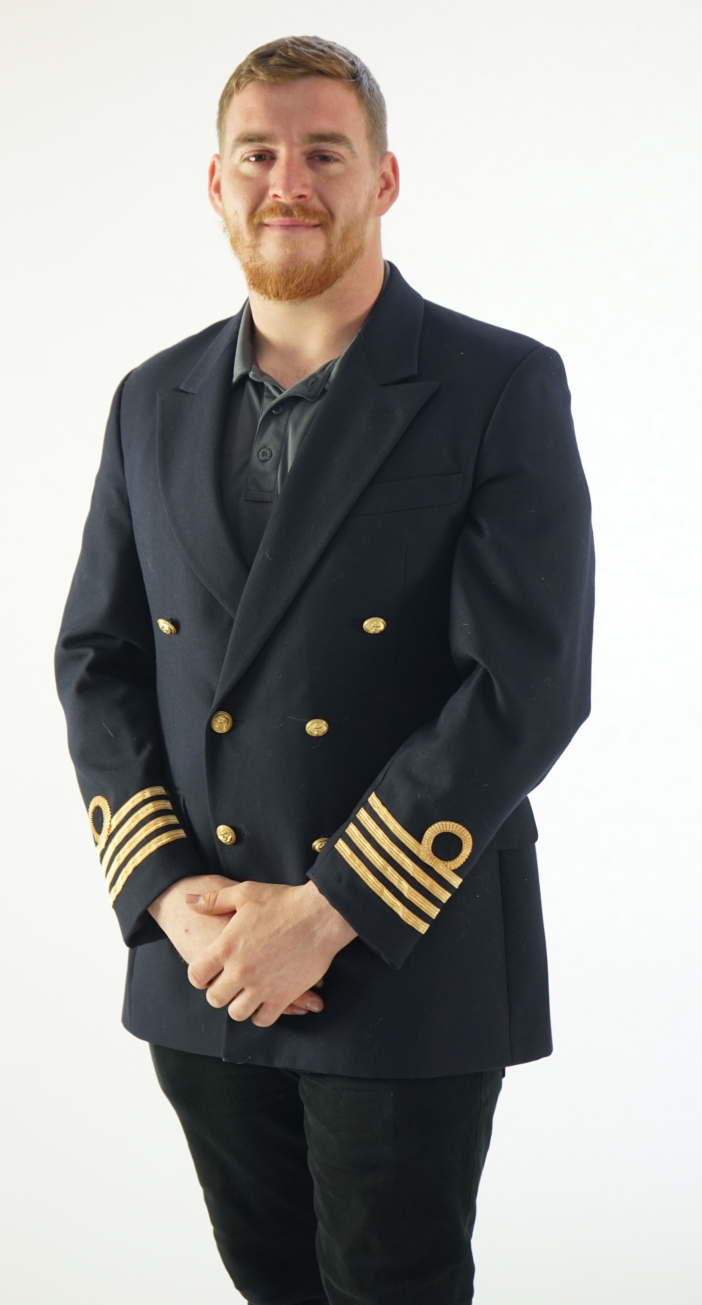 A modern naval style black-navy uniform jacket with gold trim.